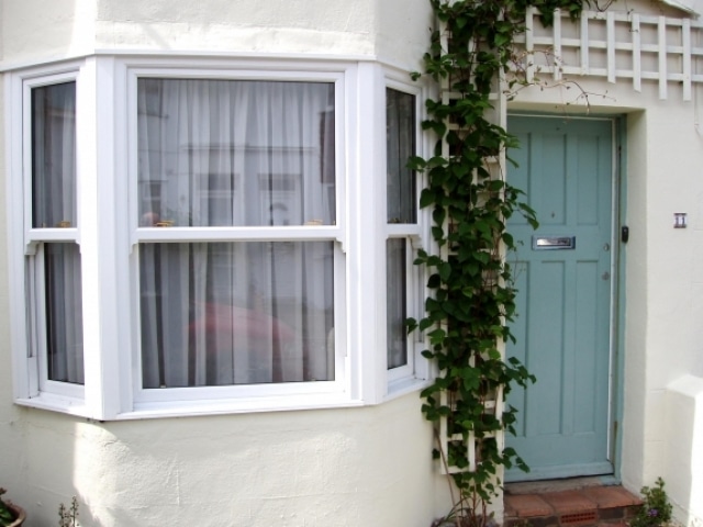 sash window on a house with a green door