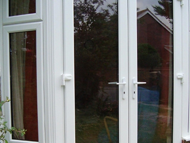 UPVC double glazed French windows showcasing a modern design with clear glass and sleek frames.
