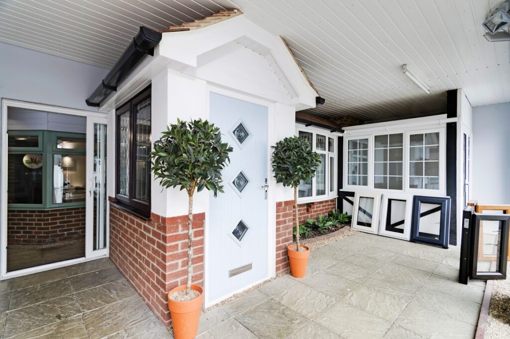 showcasing Sliding sash windows. front door with 3 windows and two trees either side.