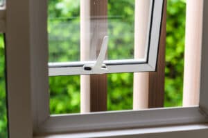 Opened aluminium window with latch handle - unlocked